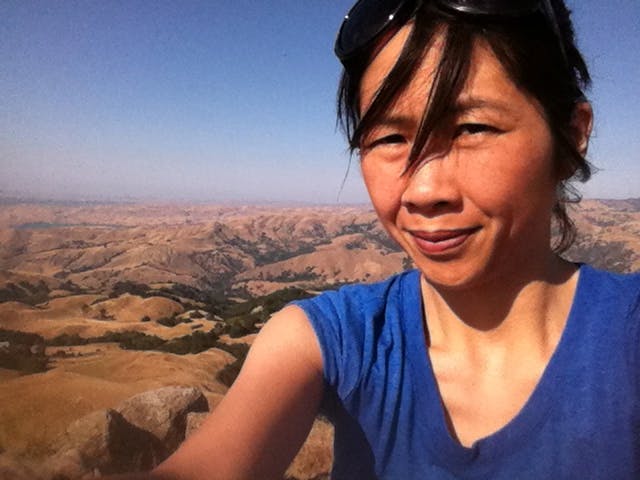 Photo of Sharon on a hike overlooking the hills below